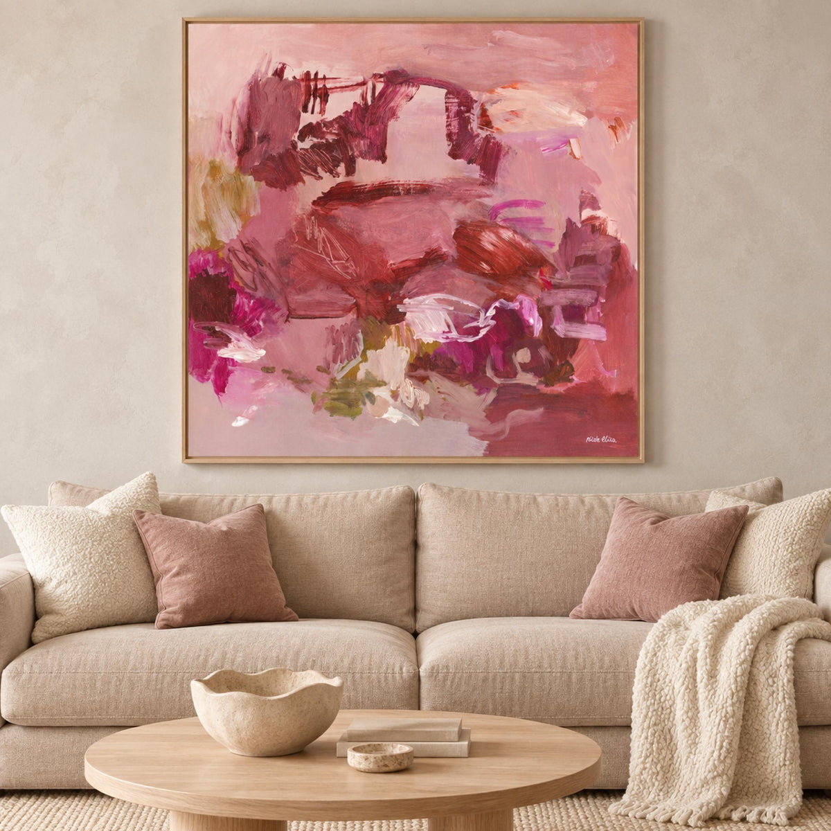 Auburn Echoes wall art above a light neutral sofa in a warm contemporary living room