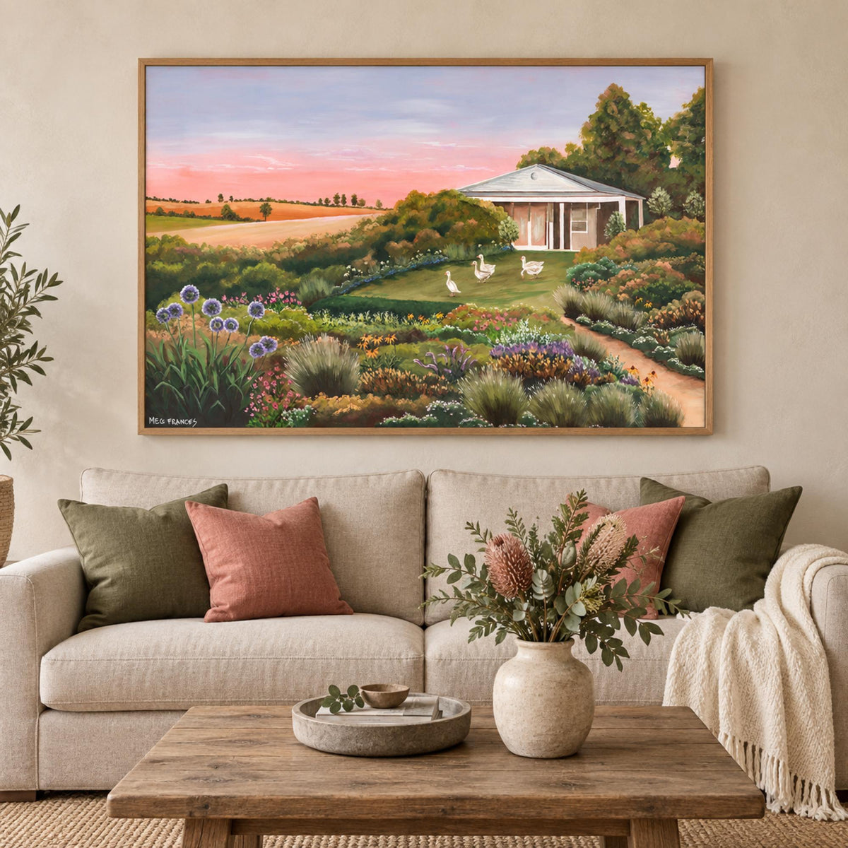 Country Garden wall art centred above an oatmeal sofa in a warm contemporary country living room