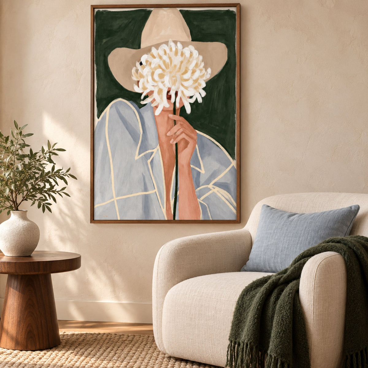 Cowgirl Mum by Lady Hana in a slim walnut frame above a cream armchair, styled with a powder-blue cushion and forest-green throw.