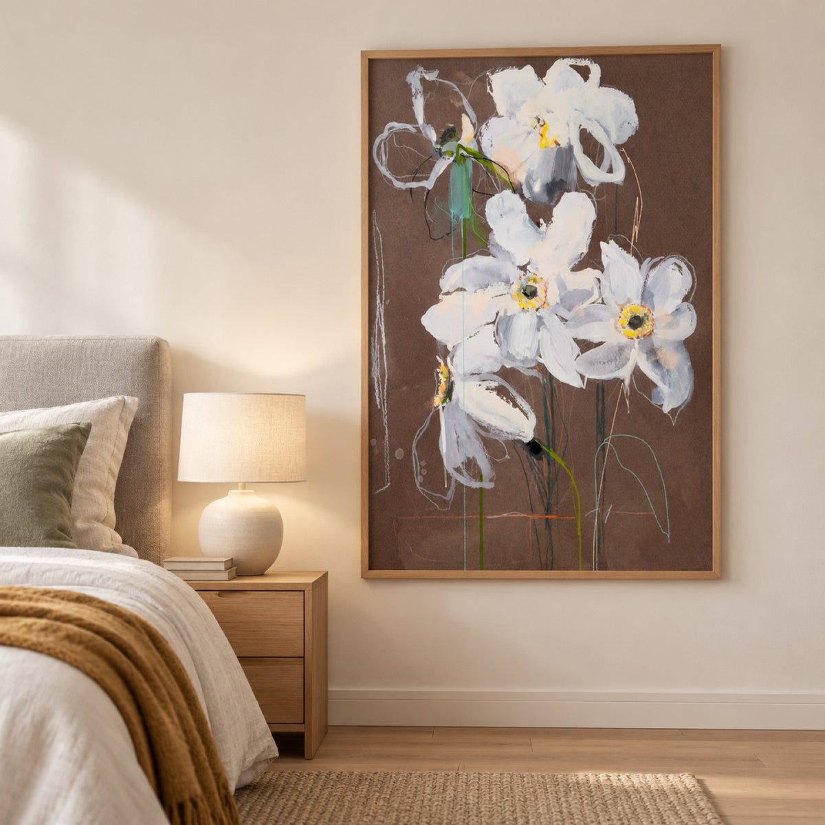Daffodil in an oak frame beside a light bed with sage and ochre textiles and an oak bedside table.