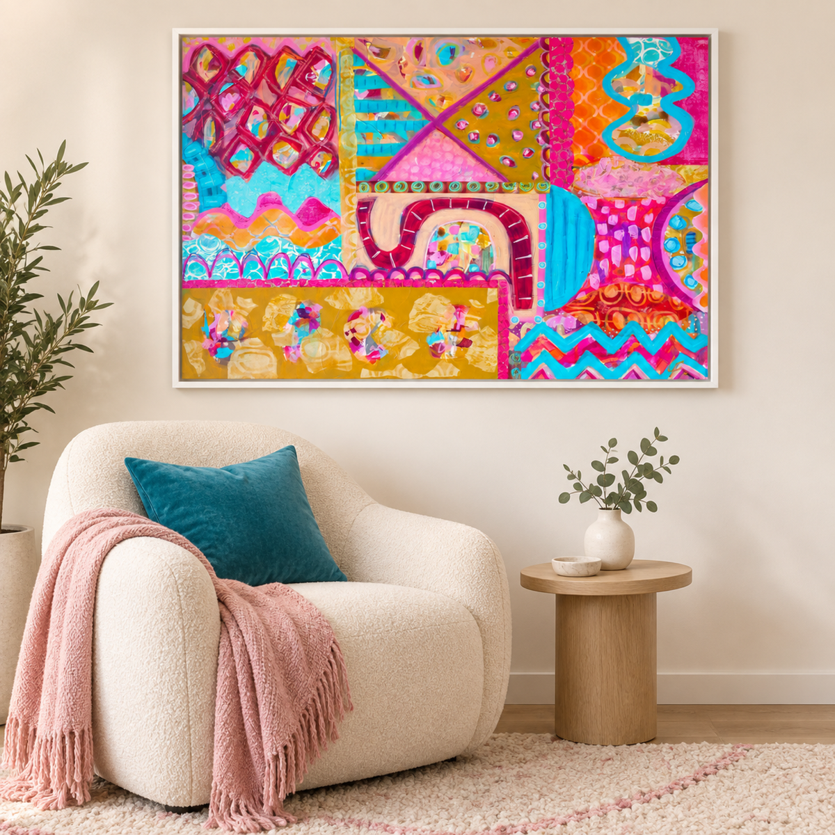 Festival in the Fields by Lindy Farley in a white frame above a cream chair with turquoise and soft pink textiles.