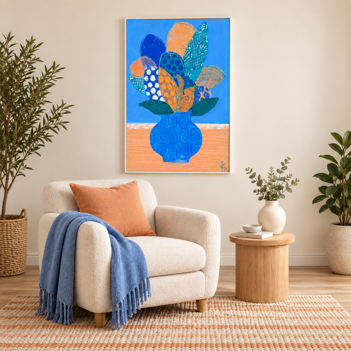 Frances by Lindy Farley in a white frame above a cream chair with apricot and blue textiles.