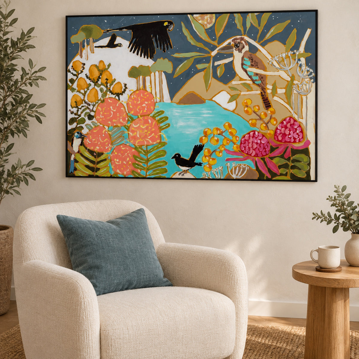 A Moonlit Night in a slim black frame above a cream reading chair with a blue cushion and natural oak side table.