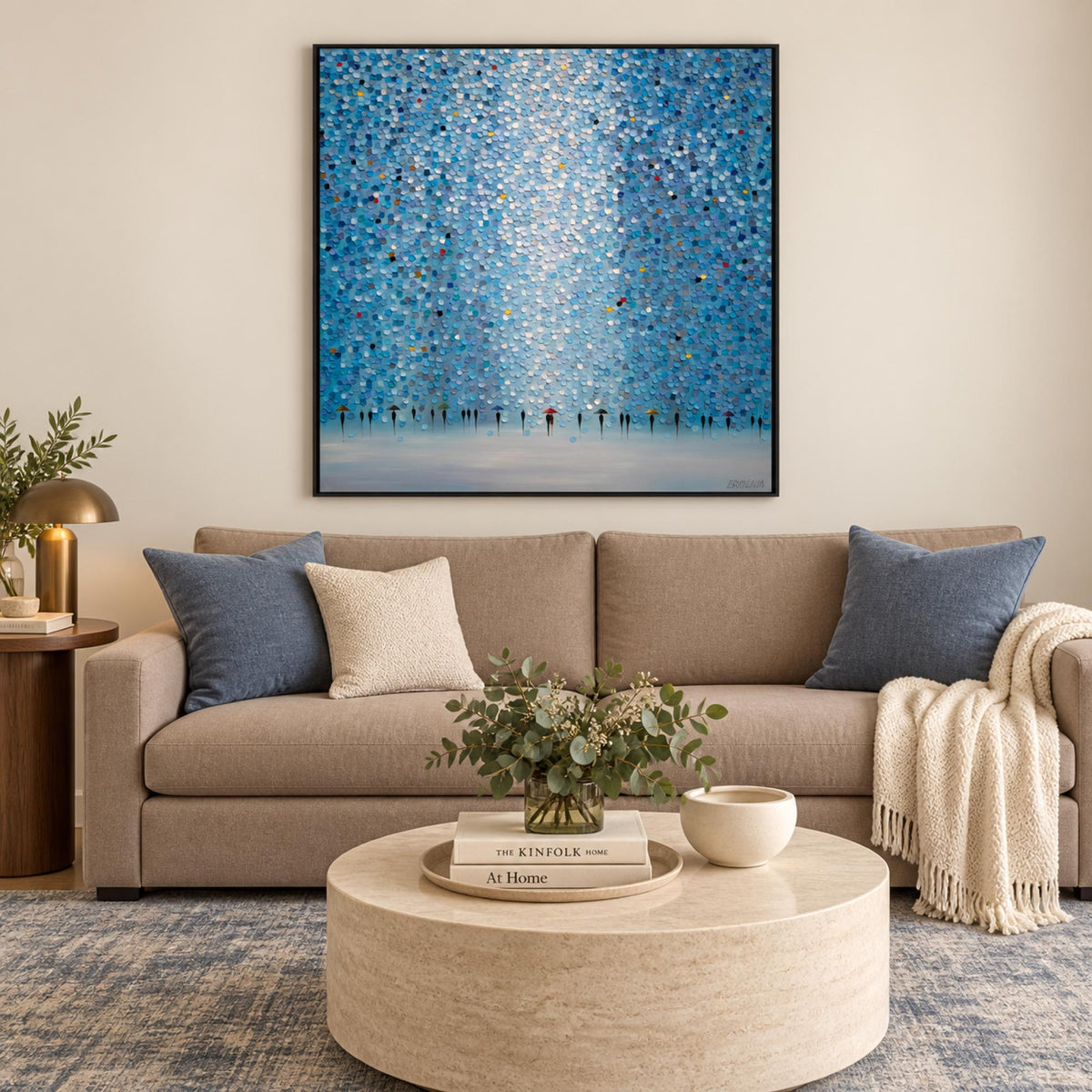 Moonlight Rain in a black frame above a taupe sofa with blue cushions and walnut accents.