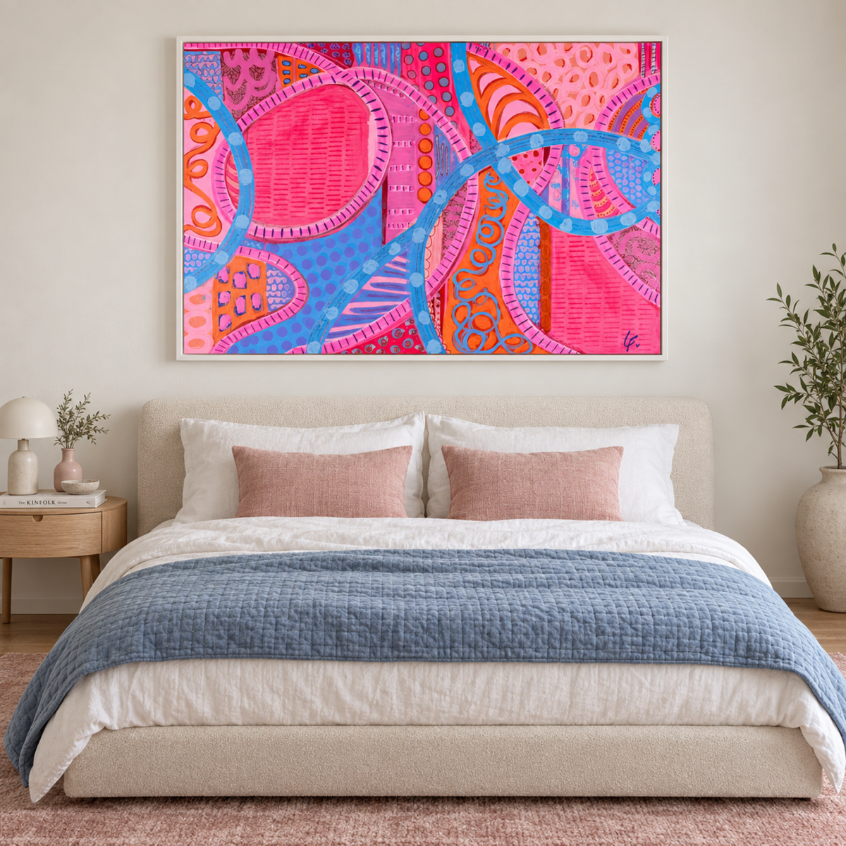 Shibuyu Scramble Vibes by Lindy Farley in a white frame above a cream bed with blue and pink textiles.