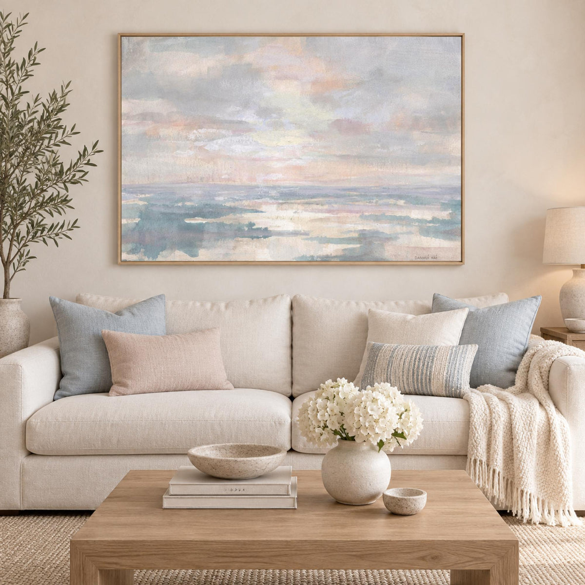 Still Water wall art centred above a light coastal sofa
