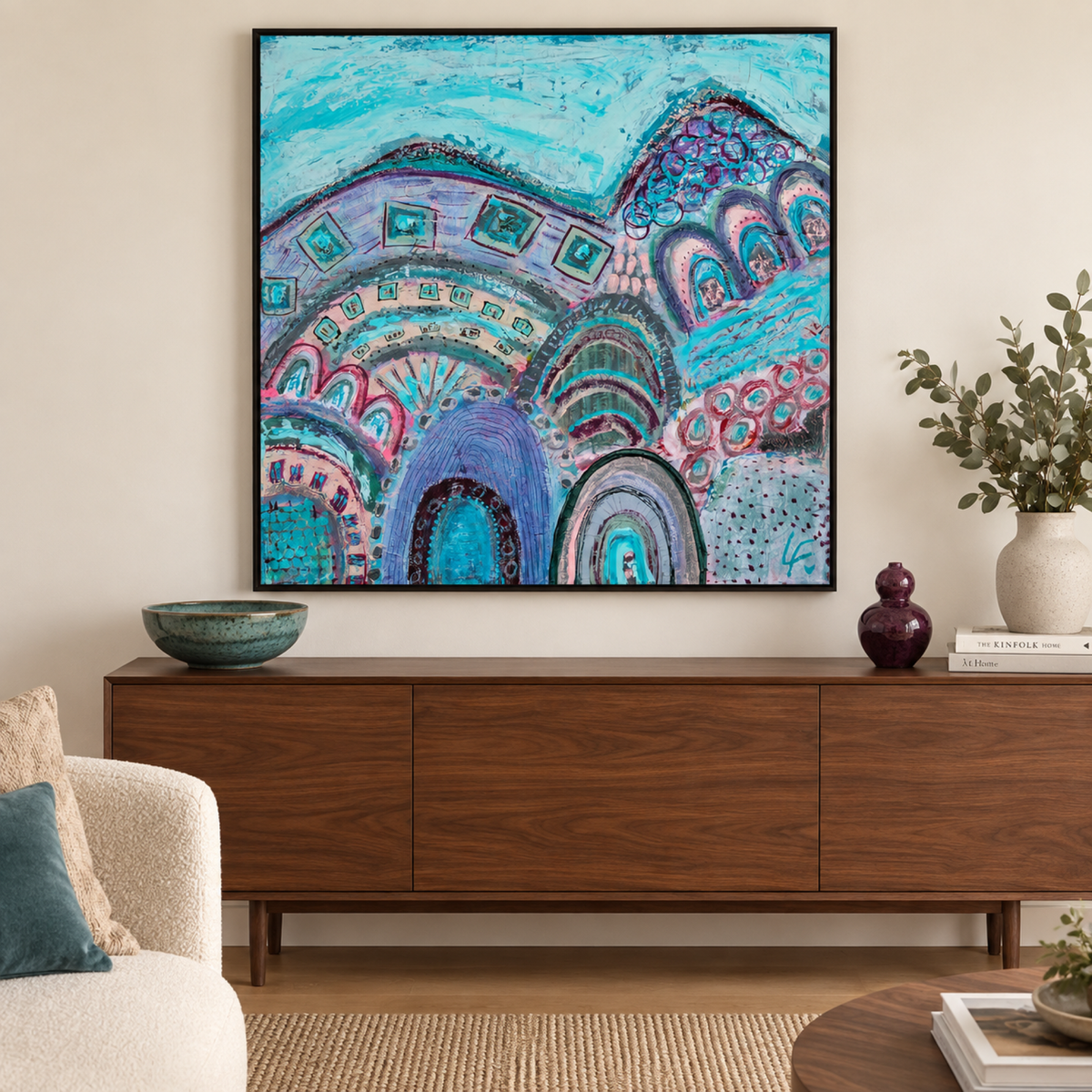 Through the Arched Window by Lindy Farley in a black frame above a walnut console with teal and plum ceramics.