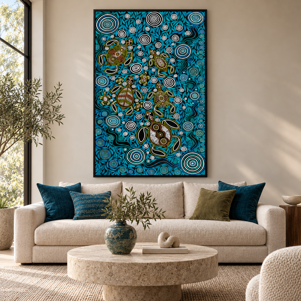 Turtles In Deep Water Dreaming by Emma Rigney in a black floating frame above a neutral sofa with teal accents.