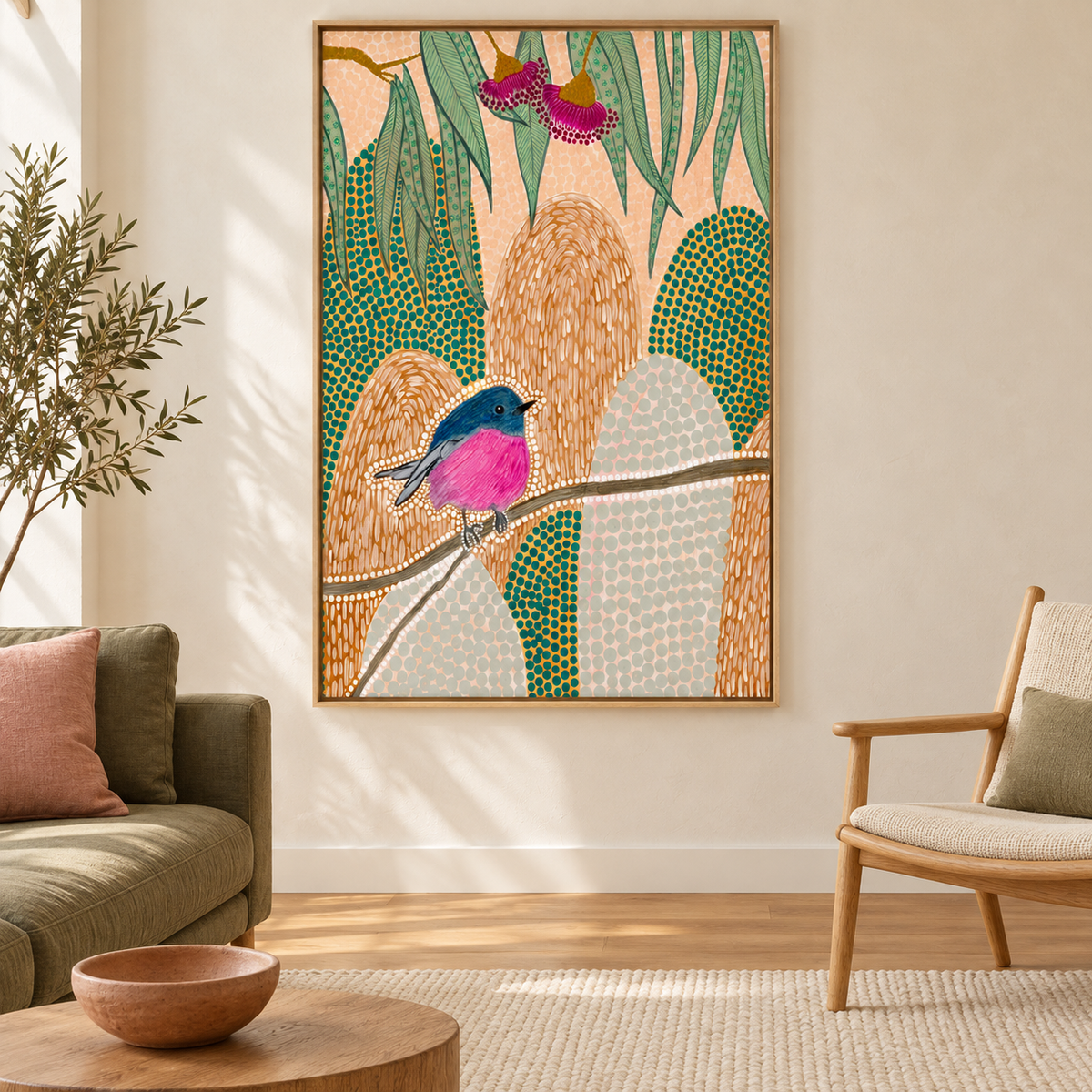 A framed vertical art print featuring a colorful bird perched on a branch against a botanical background, displayed on a beige wall in a modern living room setting with a sofa, armchair, and wooden table.