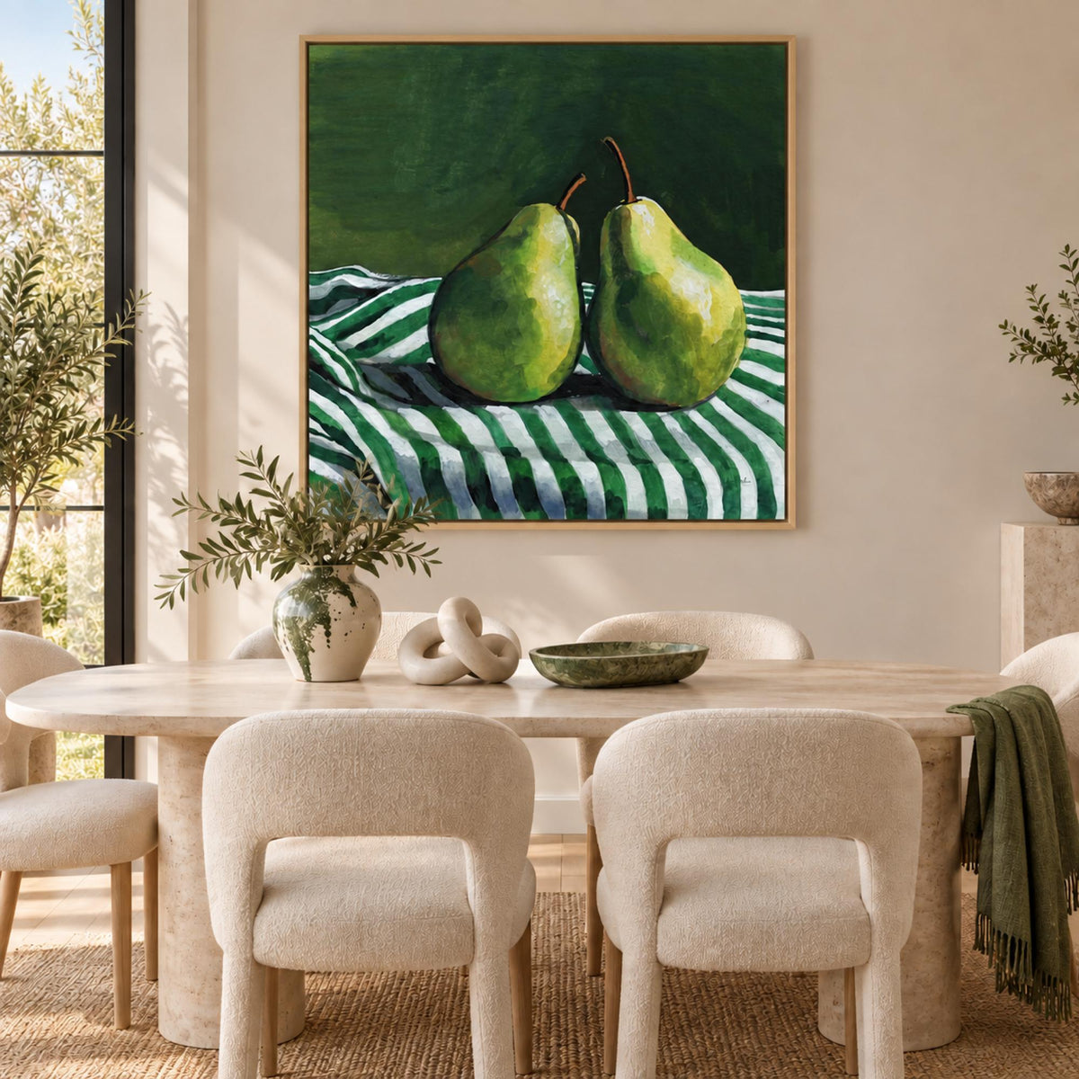 A Pair of Pears On Tablecloth by Kate Jarvik Birch in an oak floating frame above a contemporary dining table.