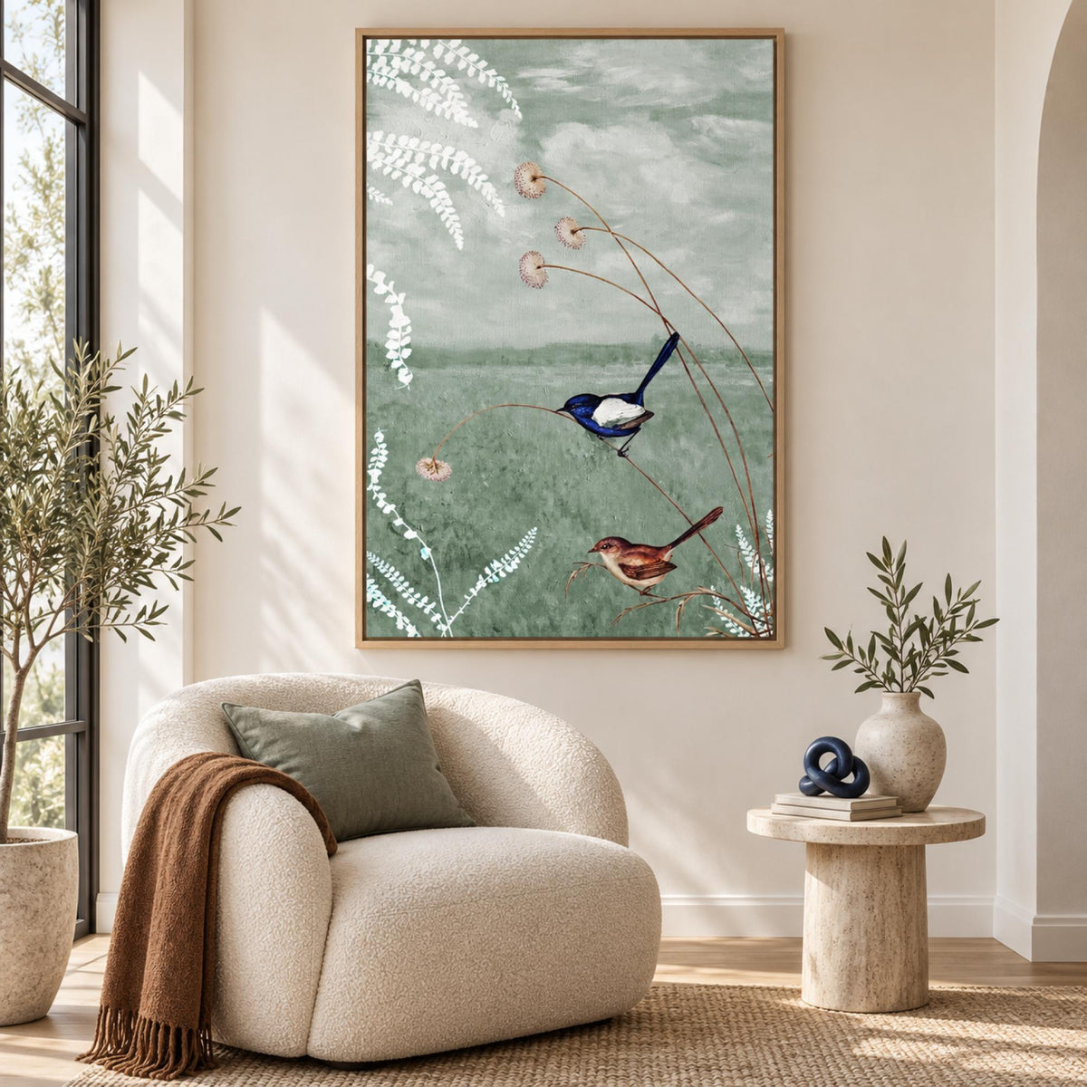 Birds in a Serene Meadow by Wild Violets in an oak floating frame above a cream lounge chair.