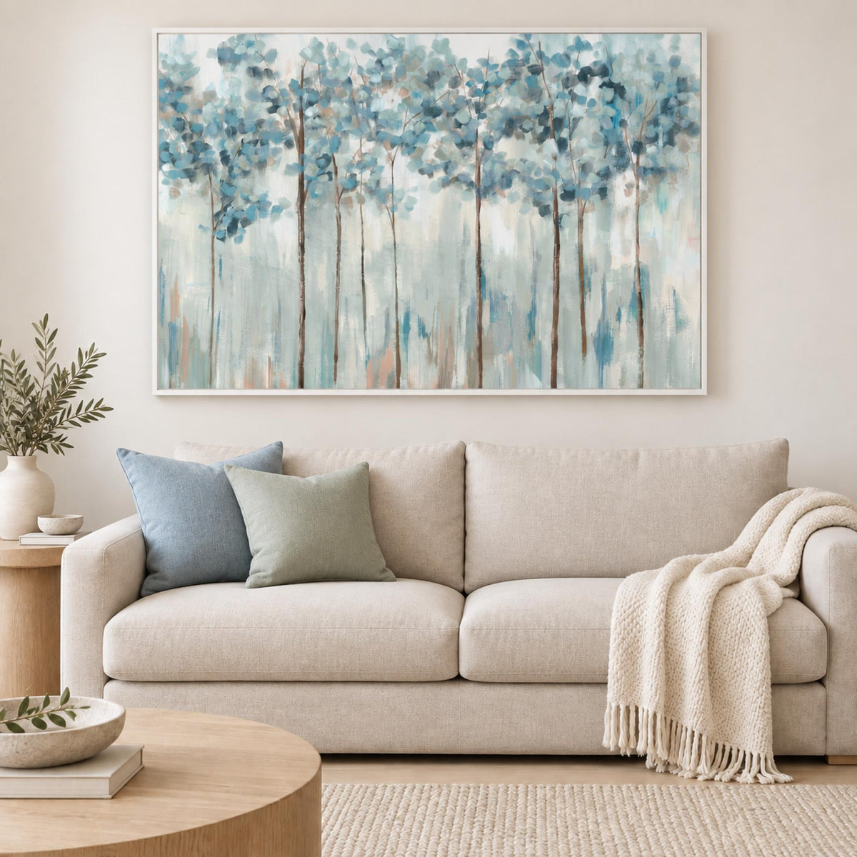 Blue Forest wall art centred above a contemporary coastal sofa