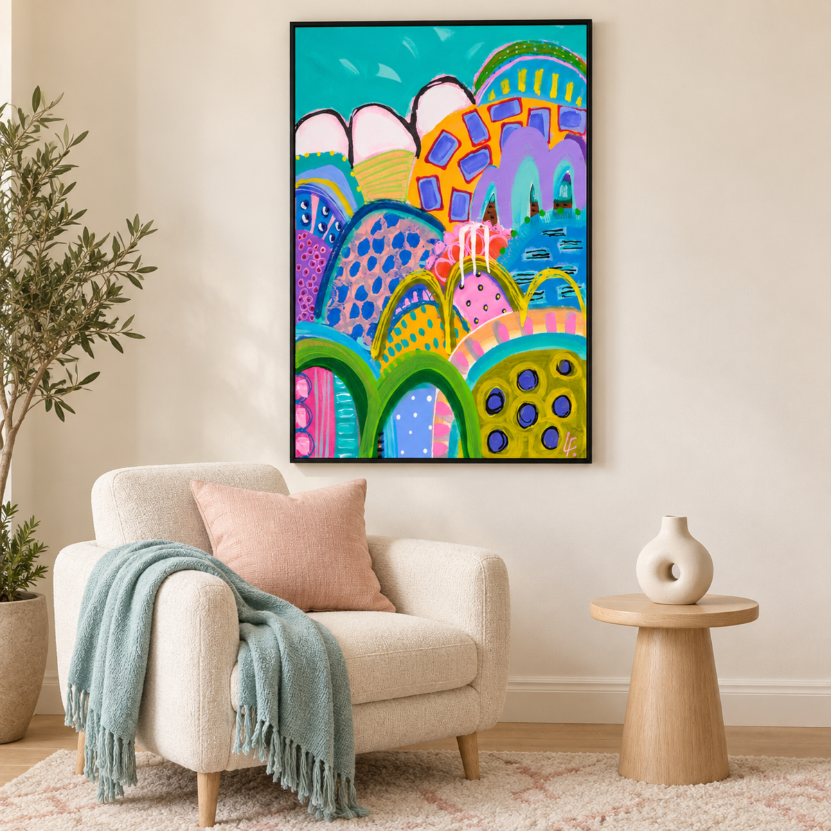 Blue Sky Tango by Lindy Farley in a black frame above an ivory armchair with blush and aqua textiles.