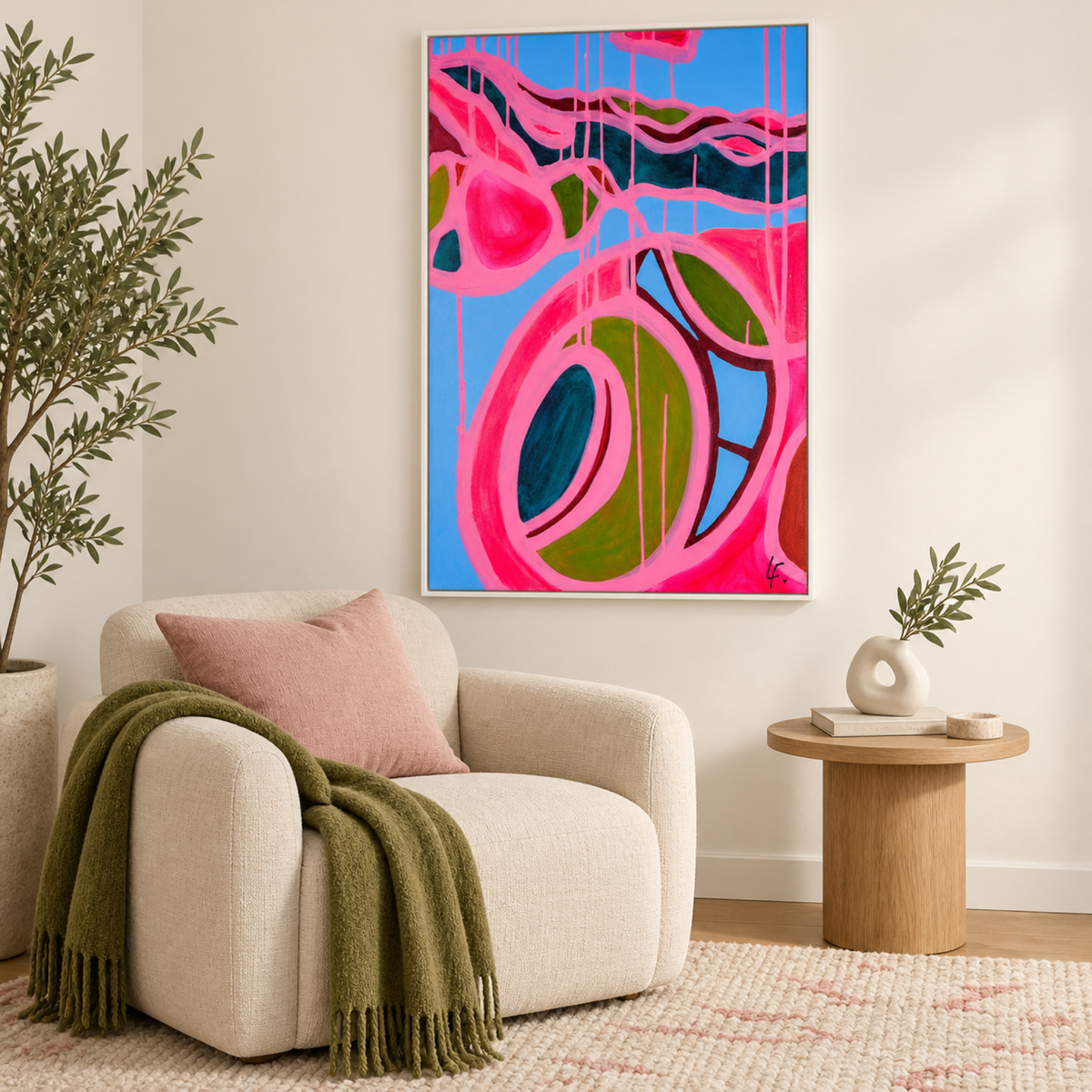 Capri Dreaming by Lindy Farley in a white frame above a cream lounge chair with pink and olive textiles.
