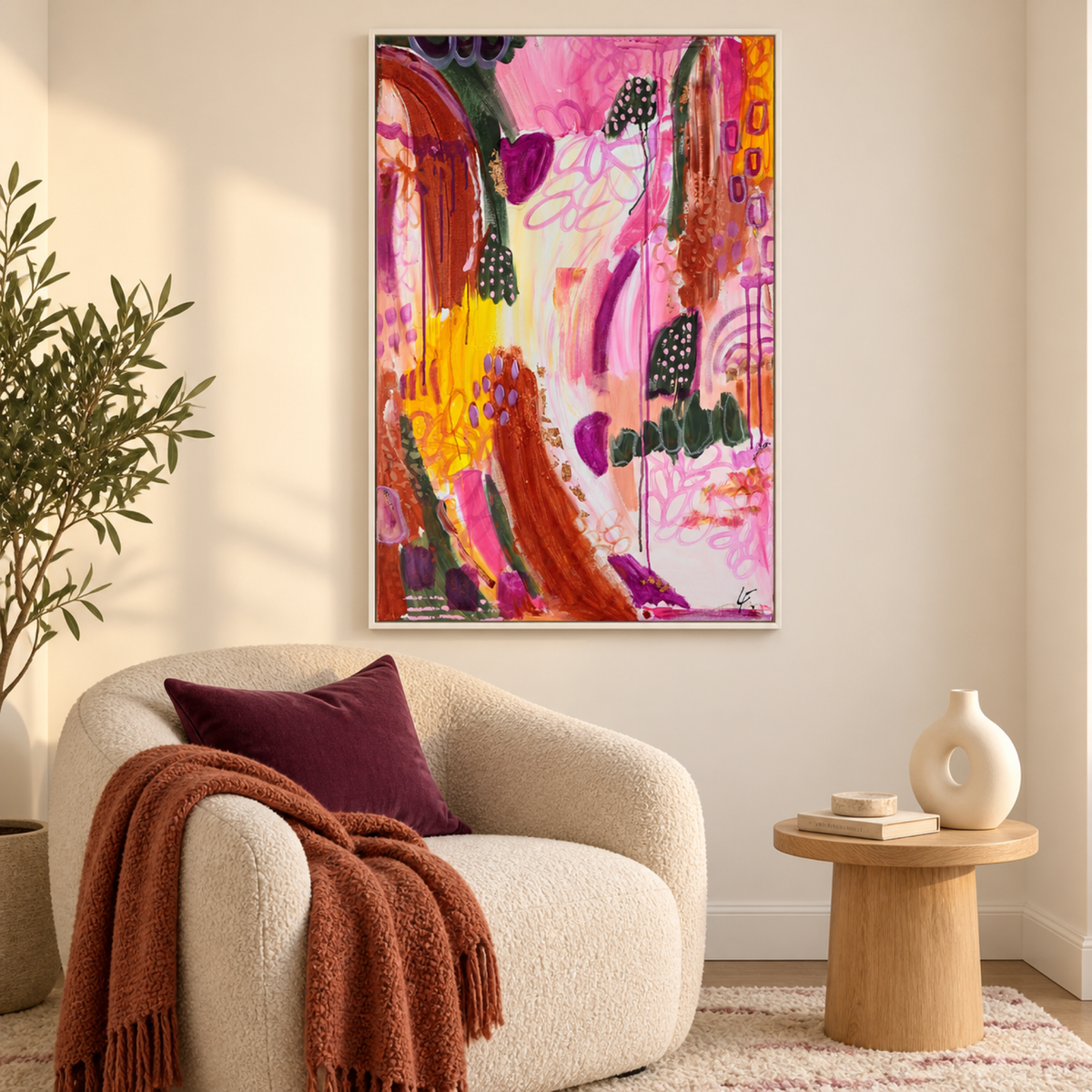Caught in the Moment by Lindy Farley in a white frame above a cream chair with plum and rust textiles.