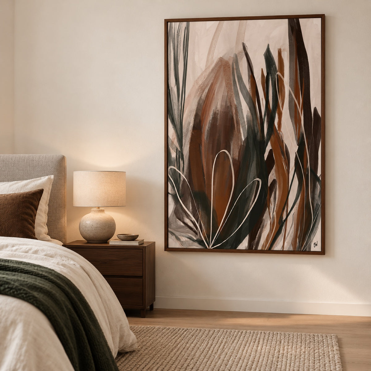 Earthen Stillness in a walnut frame beside a light bed with ivory linen, a forest-green throw and walnut bedside table.