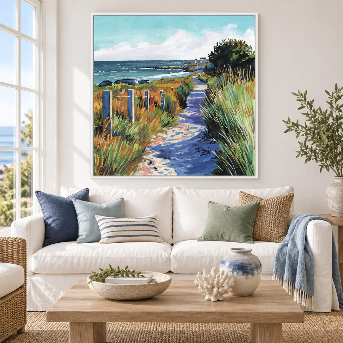 Fresh Ocean Air by Kate Jarvik Birch in a white floating frame above a Hamptons-style white sofa.