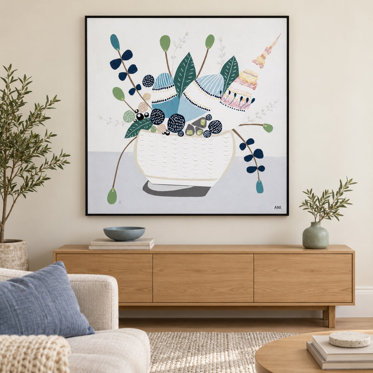 Hamptons Bouquet, Style B in a slim black frame above an oak console in a softly lit contemporary living room.