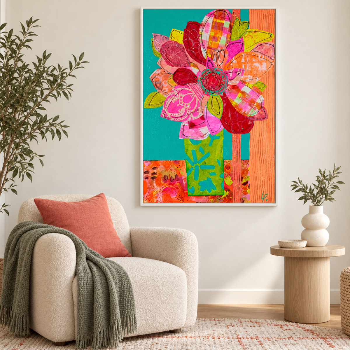 Petals Aglow by Lindy Farley in a white frame above a cream chair with coral and muted green textiles.