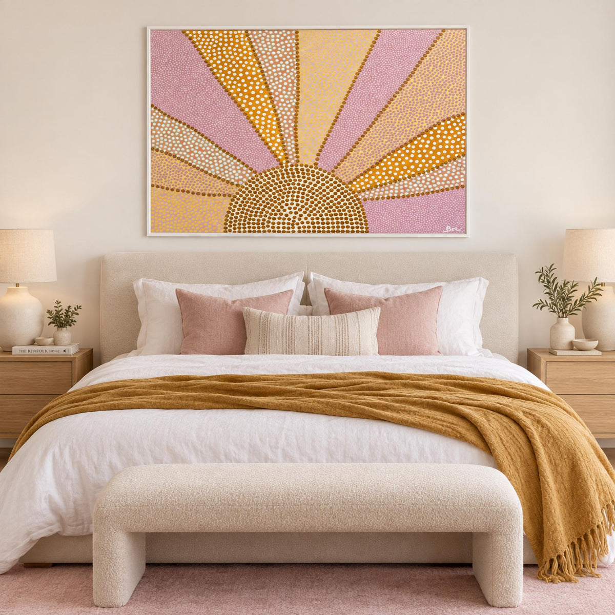 Rising Golden Yaraay in a white frame centred above a cream bed with pink and ochre textiles.