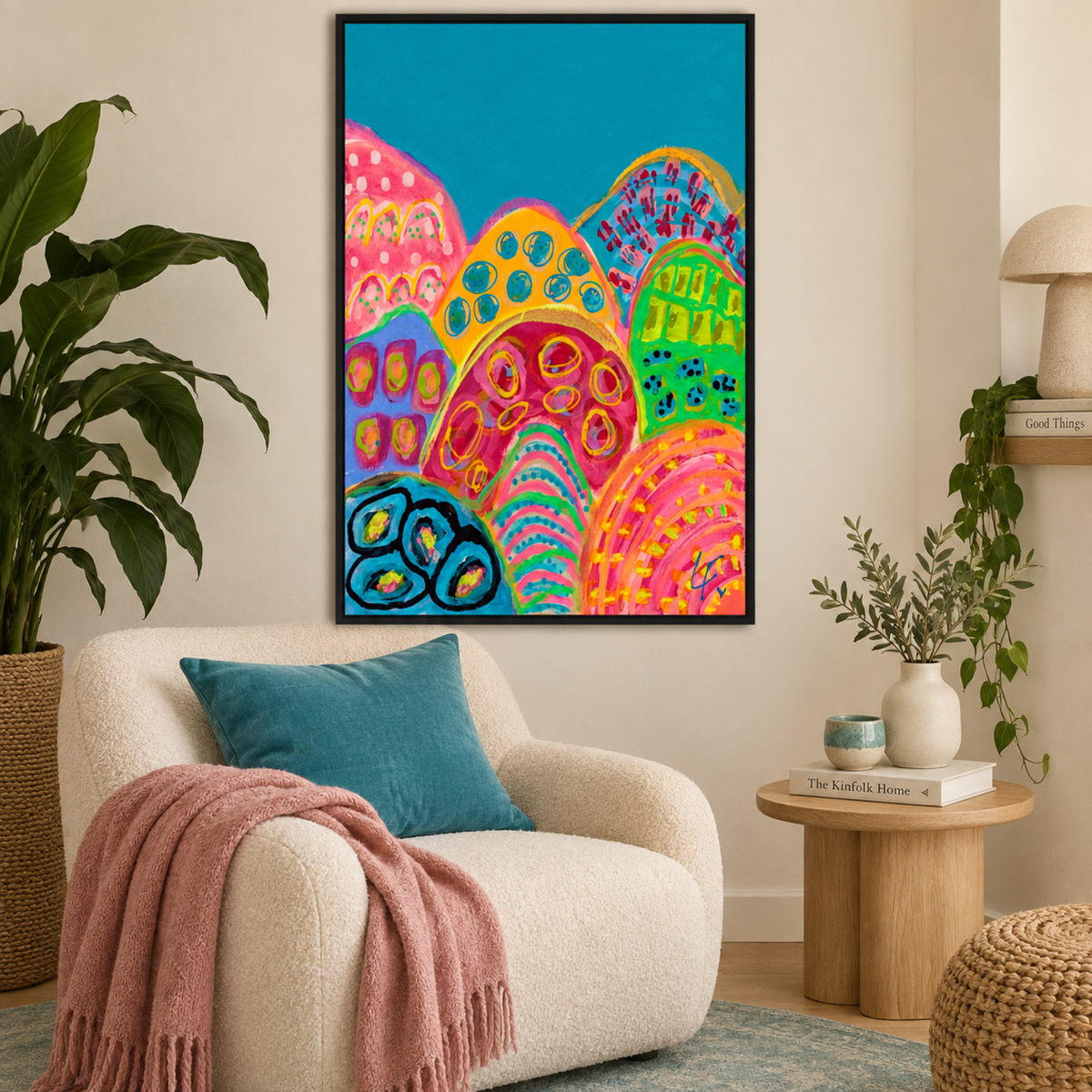 Seaweed Disco by Lindy Farley in a black frame above a cream reading chair with turquoise and pink textiles.