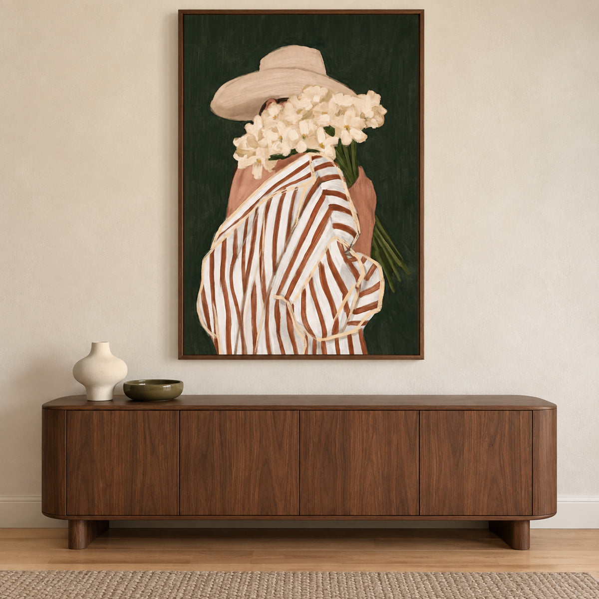 Sunday Cuttings by Lady Hana in a slim walnut frame above a curved walnut sideboard with cream and olive ceramics.