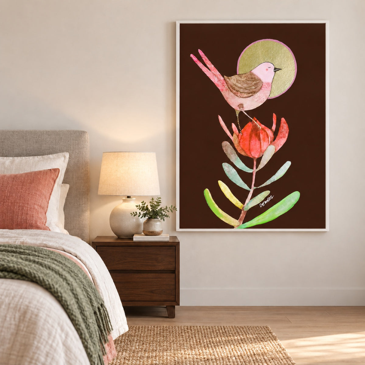 Taiyo in a white frame beside a light bed with coral and soft green textiles and a walnut bedside table.