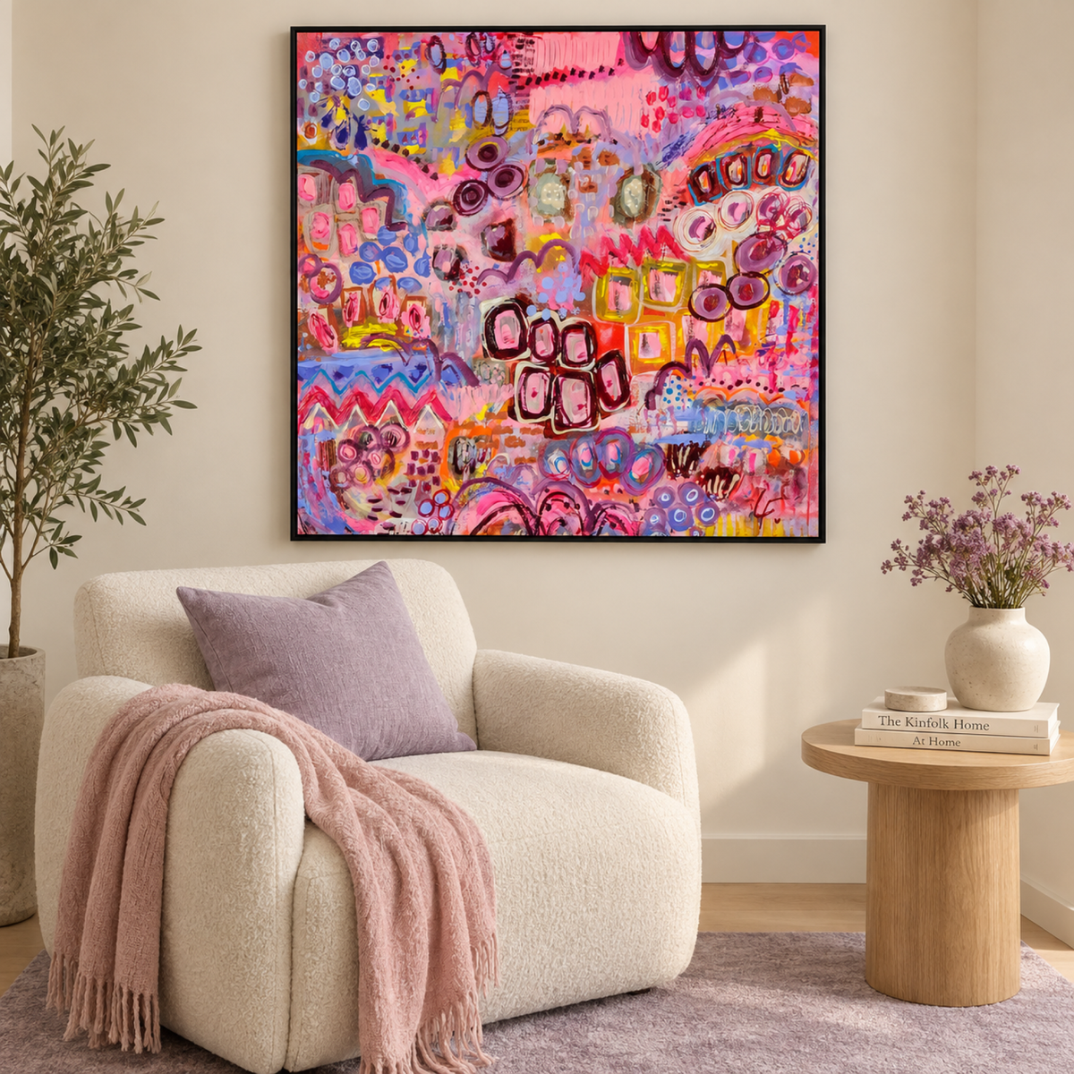 The Orchards by Lindy Farley in a black frame above a cream chair with lilac and blush textiles.