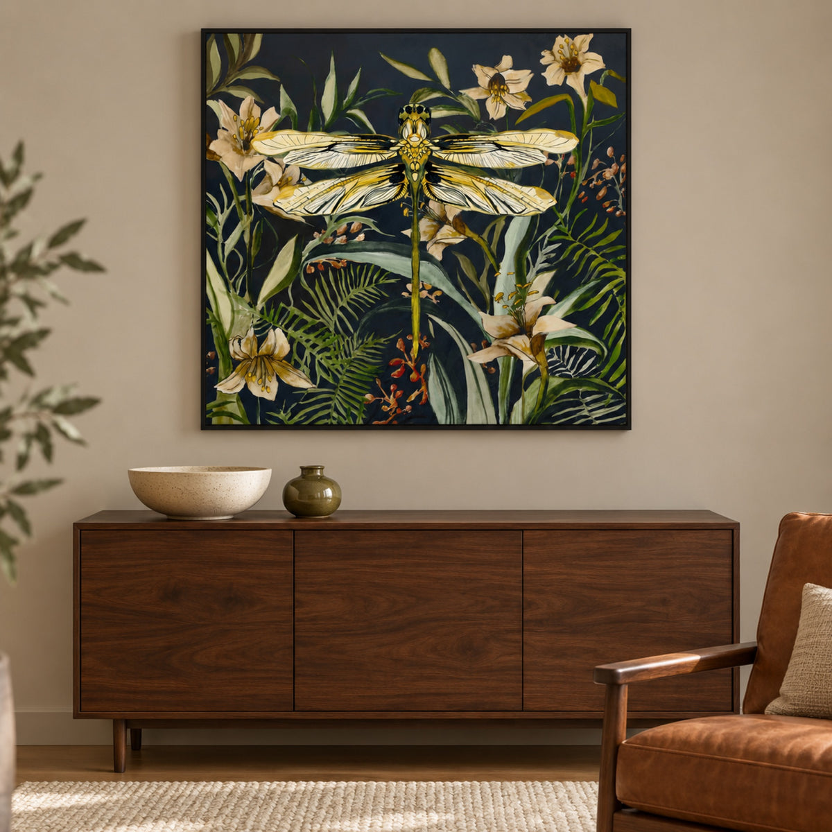 Whispers of the Dragonfly displayed in a black frame above a walnut buffet.