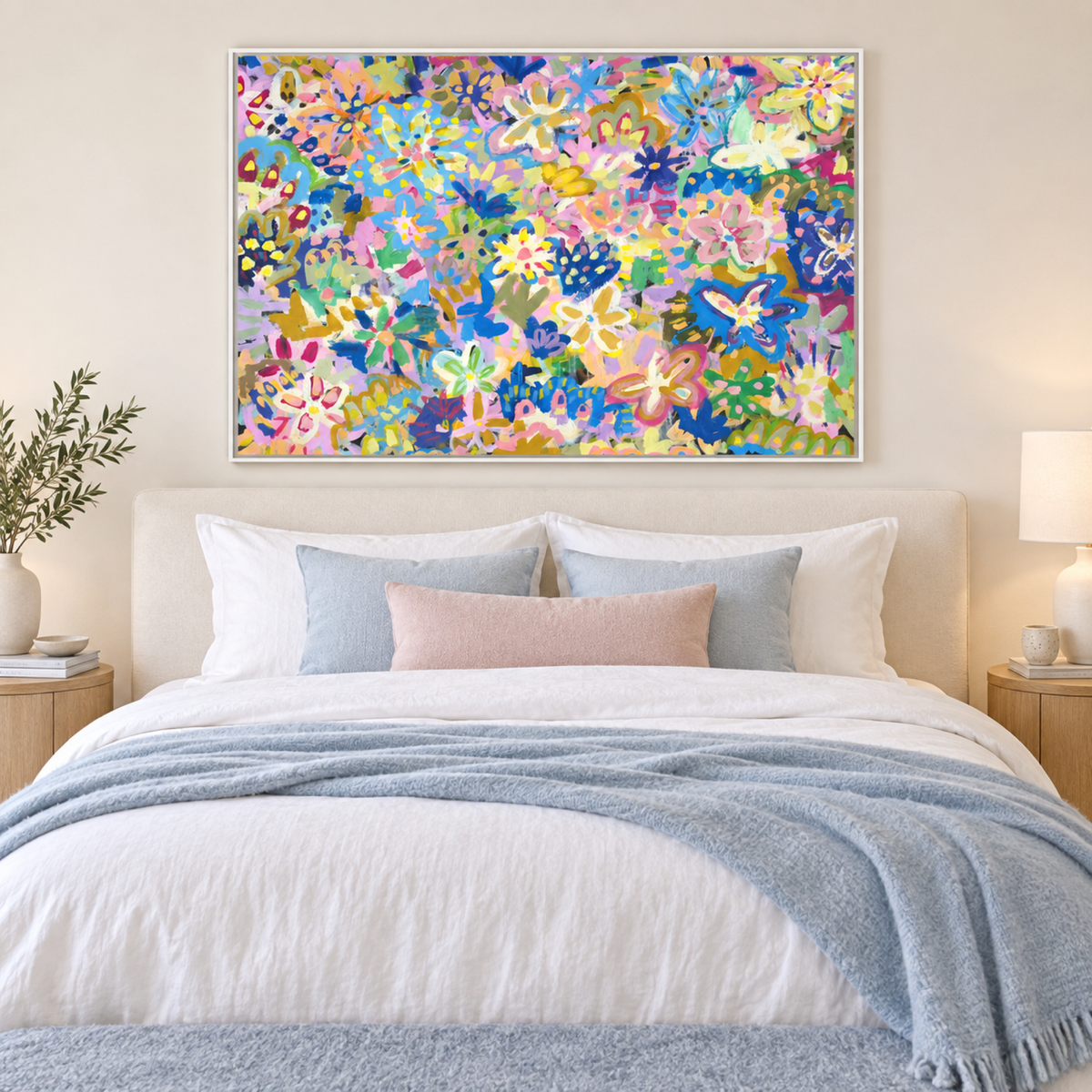 Wildflower Heart in a white frame centred above a cream bed with blue and blush textiles.